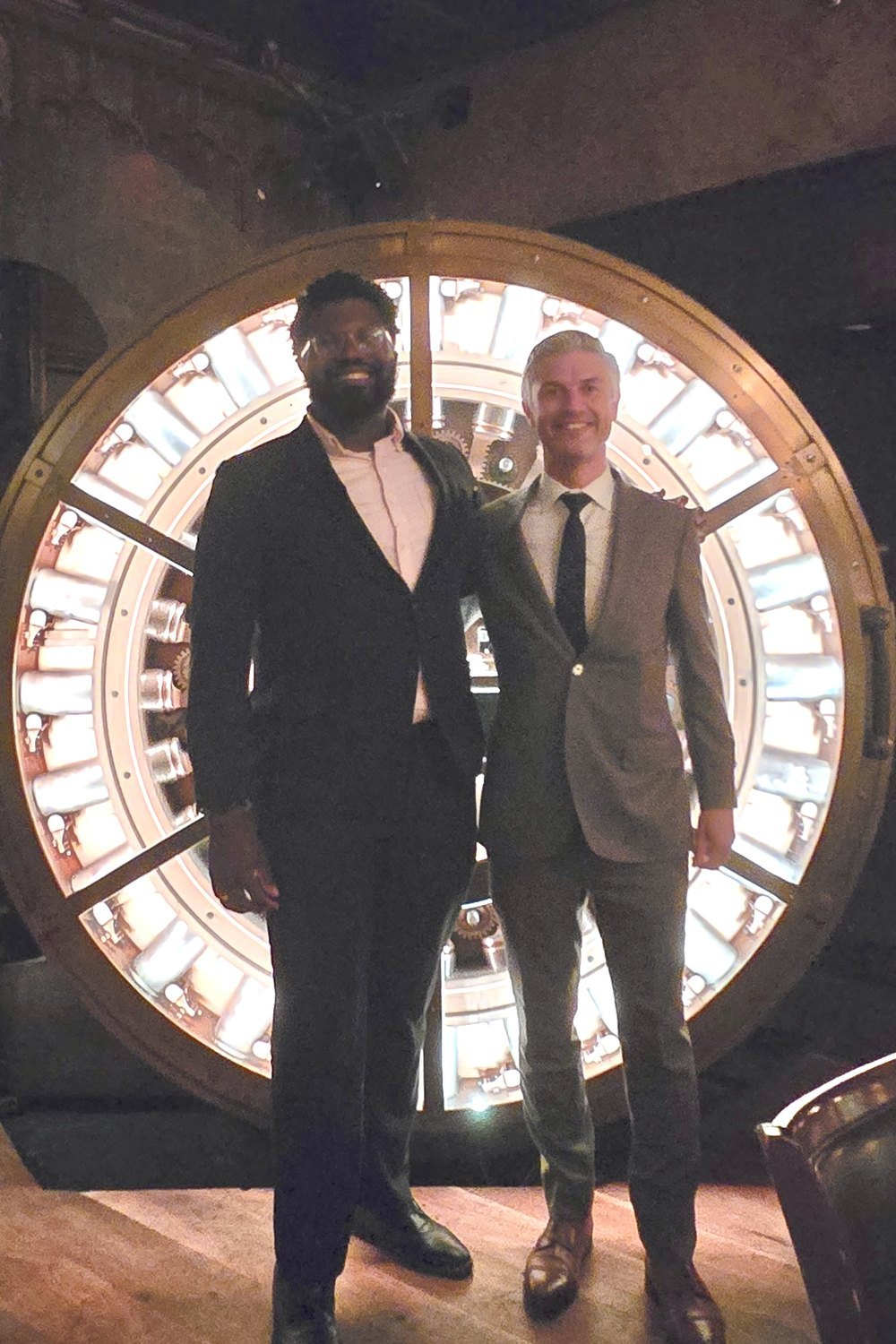 Otuoze Baiye and Fred Schwark standing in front of the vault door at
                    The Vault at Trinity Place.